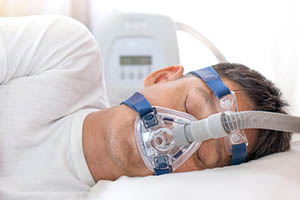 man sleeping with cpap mask