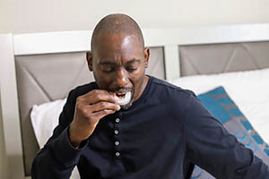 bruxism - man putting mouthguard in