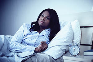 insufficient sleep syndrome - woman awake in bed