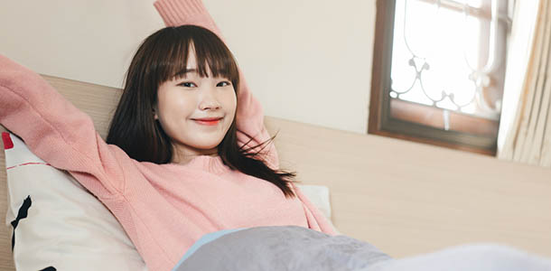 energized teen girl waking up in bed